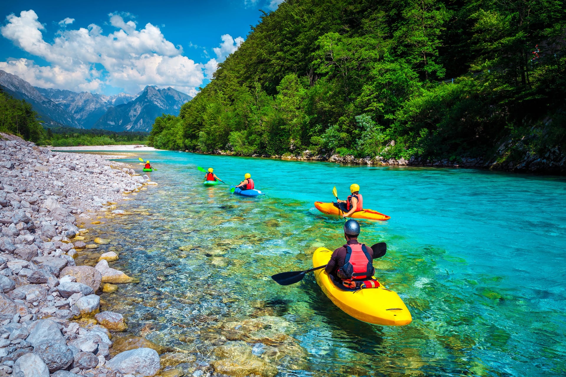 Sporty kajakkpadlere på den vakre turkise Soča-elven, Bovec, Slovenia