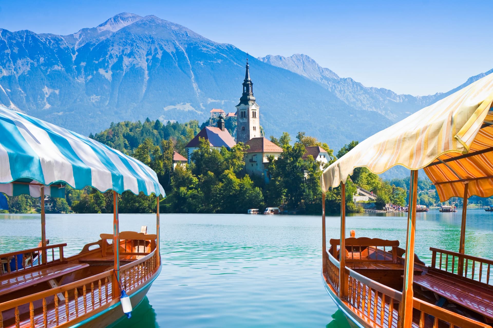 Typical wooden boats, in slovenian call "Pletna", in the Lake Bled, the most famous lake in Slovenia with the island of the church (Europe - Slovenia)
