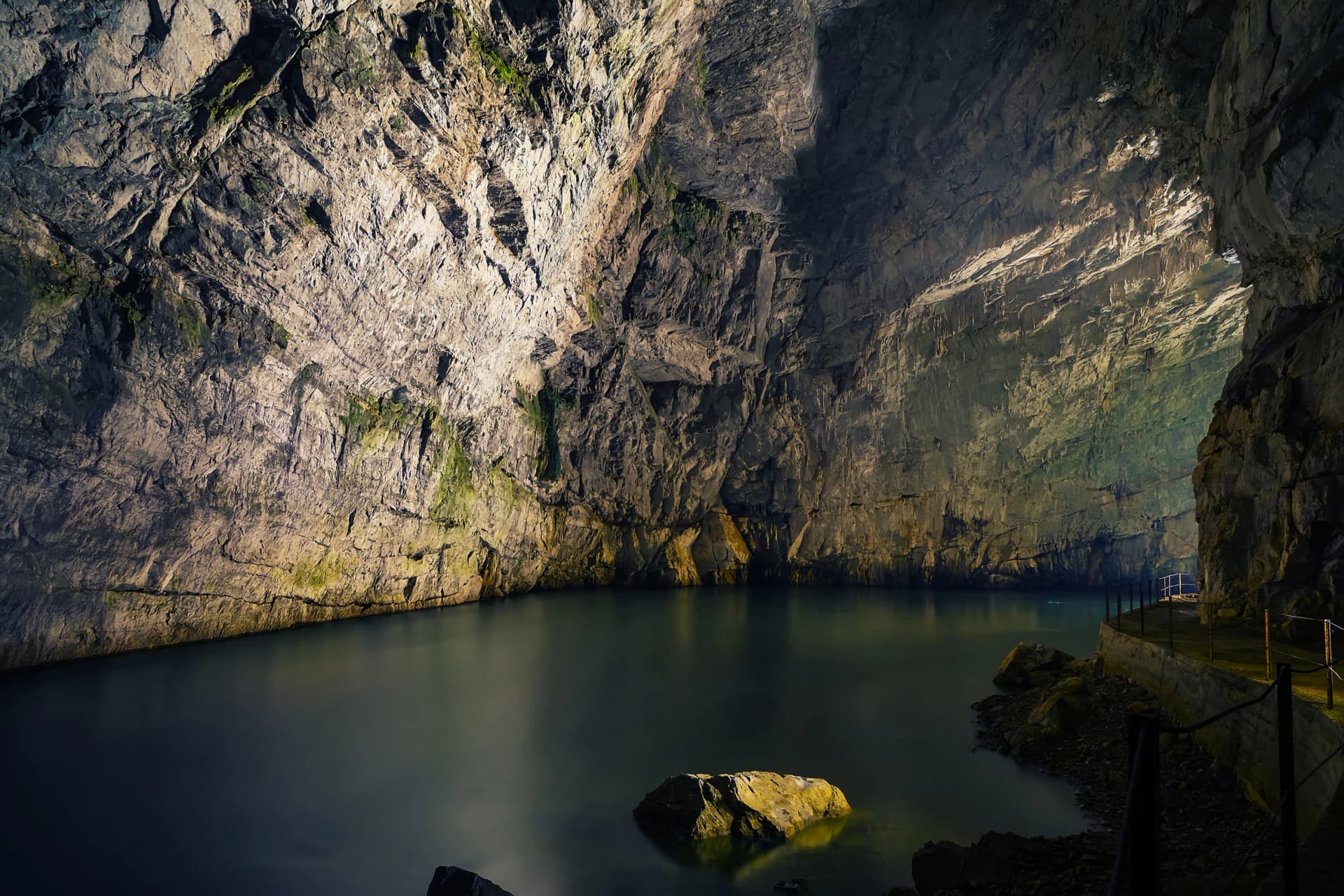 Long exposure photo of underground Planina cave in Slovenia with river running through