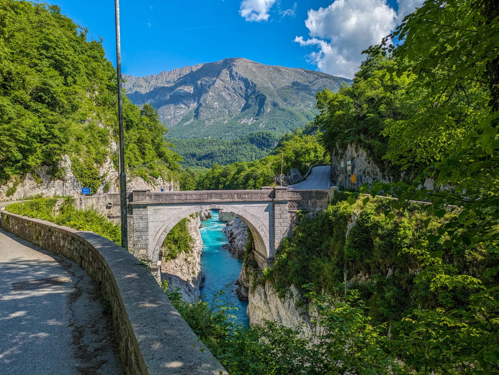 Soca Valley, Slovenia – Aerial view of the emerald-green Alpine River Soca on a bright sunny summer day with green foliage..The last wild river in Europe in Triglav National Park near the Vricic Pass