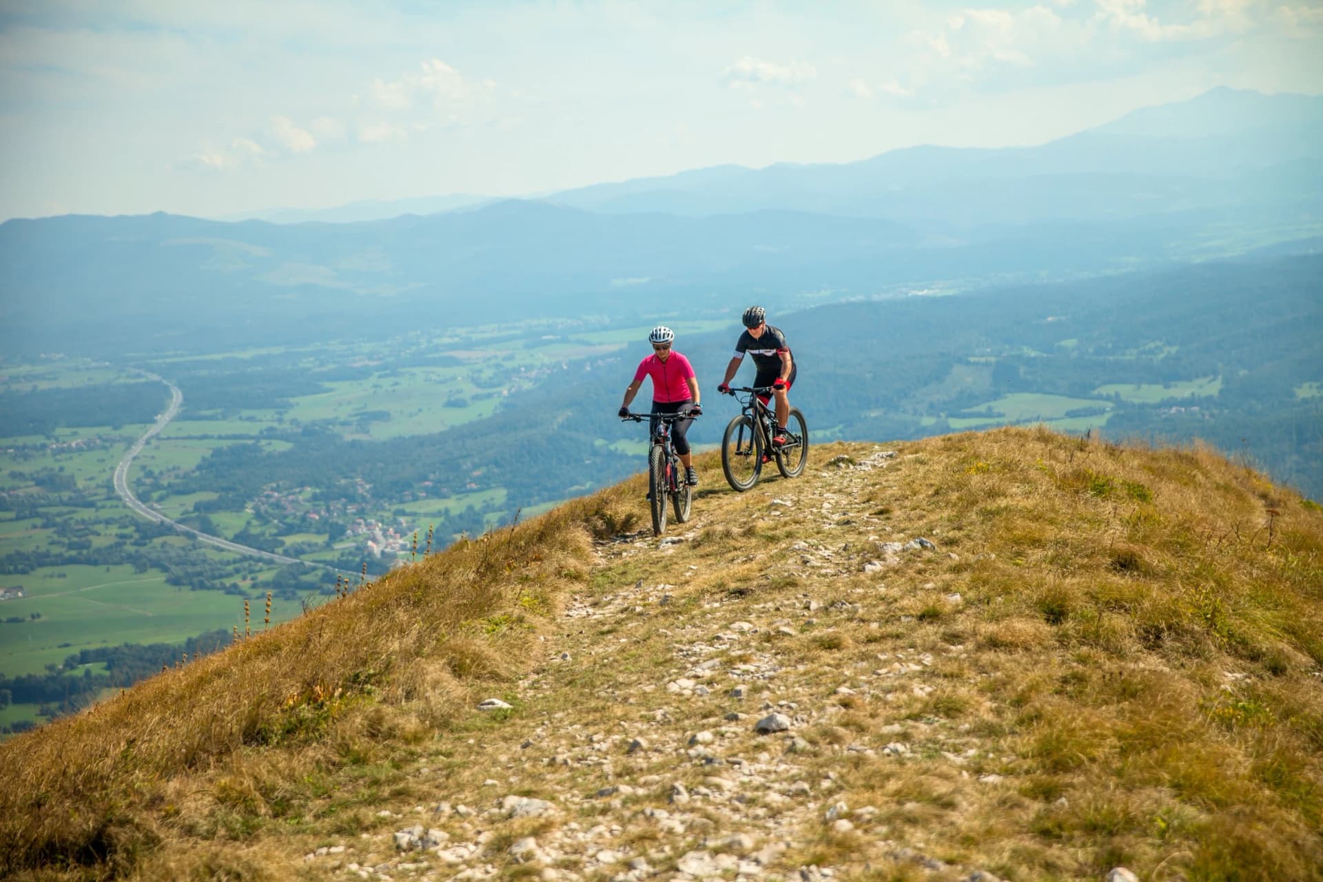 Mountain bikers on the Nanos plateau in Slovenia overlooking a beautiful Vipava valley