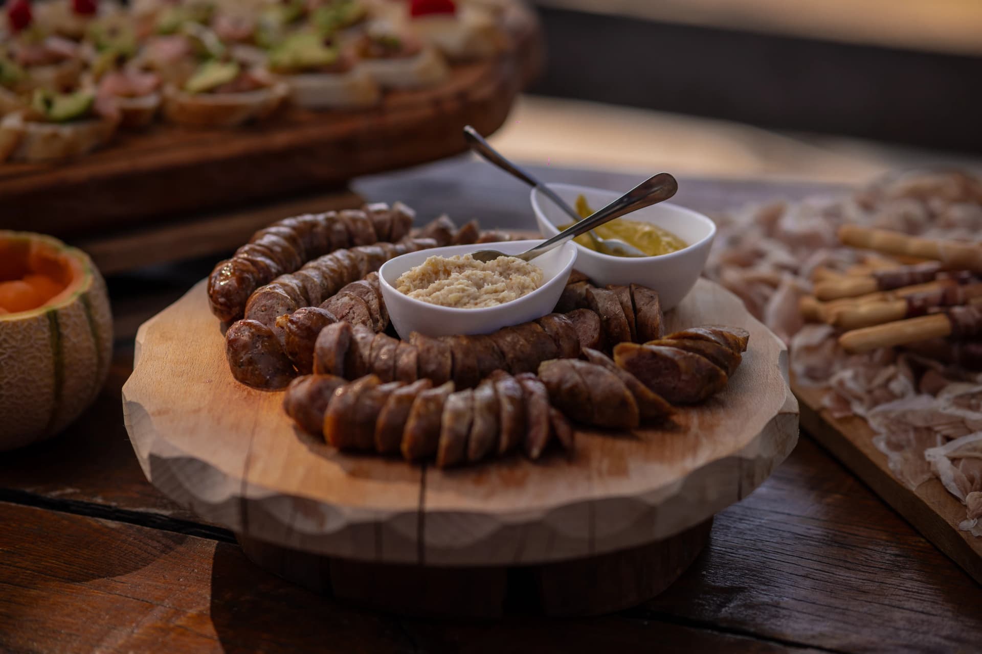 Kranjska klobasa or sausage is being served at an event, chopped sausage with mustard and other condiments. Typical slovenian food served in the mountains.