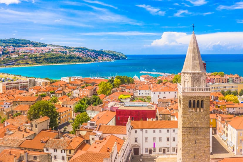 Aerial view of the city of Koper on Adriatic coast, Slovenia, showcasing its historic old town, and surrounding blue waters in a blend of cultural heritage and Mediterranean charm
